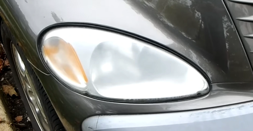 Cloudy yellow car headlights showing UV damage and oxidation before professional headlight restoration.