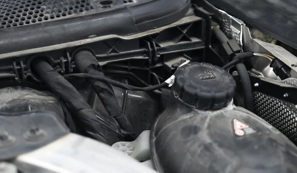 Professional engine bay detailing Medford removing years of dust, oil residue, and grime to reveal the vehicle’s engine components and condition